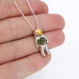 Sterling Silver astronaut pendant necklace with green moldavite glass and gold enamel helmet visor - the perfect space jewelry gift!