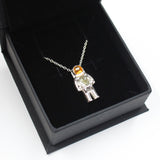 Sterling Silver astronaut pendant necklace with green moldavite glass and gold enamel helmet visor - the perfect space gift! Shown in gift box.