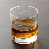 Outer space themed whiskey rocks glass showing northern summer night sky zodiac constellations