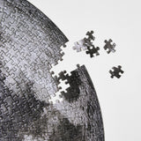 moon puzzle from Four Point Puzzles with 1000 pc round design. A space gift for space enthusiasts! Close-up of puzzle pieces.
