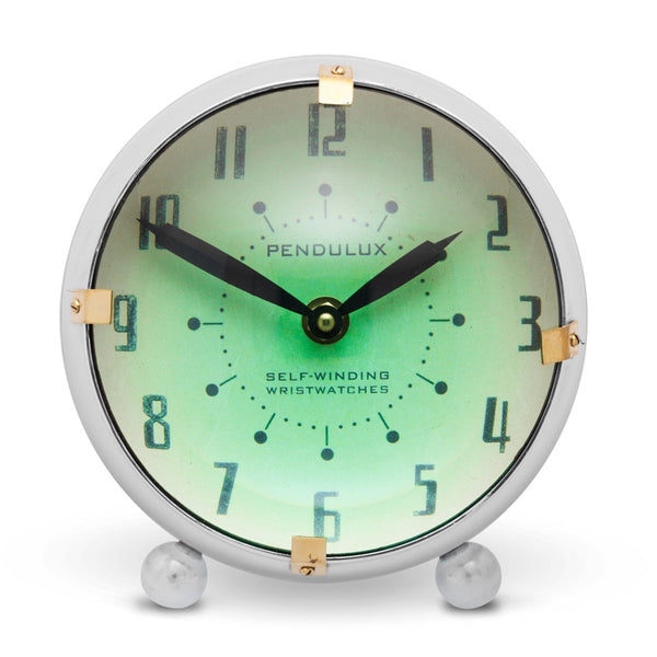 Spacey desk clock by Pendulux modeled after space age automobile dashboard clock! Green face with round convex front.