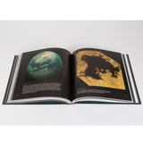 A book of cool photos of space from NASA, open to a real photo of Titan.