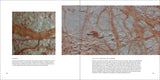 A book of photos of outer space from NASA, open to a real photo of Europa.