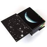 View of open box of 100 Earth and Space Postcard Set with photos from NASA, by Chronicle Books
