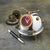 A cute space alien clock for your desk or table, by Pendulux with an aluminum and brass body, and a red face, with antennae on top to look like a bug!