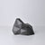 A black/dark gray, abstract geometric desk object/organize with a space-theme, resembling space rocks on the surface of a moon or planet. An interesting space-themed gift!