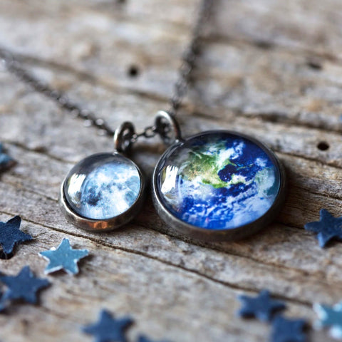 A layered space necklace featuring two pendants with the Earth and Moon under glass. A great Earth gift or Moon gift for a space lover!