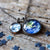 A layered space necklace featuring two pendants with the Earth and Moon under glass. A great Earth gift or Moon gift for a space lover!
