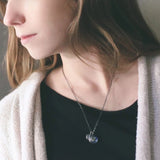 A layered space necklace featuring two pendants with the Earth and Moon under glass. A great Earth gift or Moon gift for a space lover!