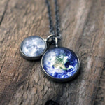 A layered space necklace featuring two pendants with the Earth and Moon under glass. A great Earth gift or Moon gift for a space lover!