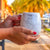 White traveler's mug with a map of the world that can be colored in. A great Earth-themed gift!