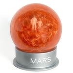 Glass Mars dust snow globe with adult and child astronaut - planet Mars space-themed gift - showing swirling Mars dust