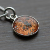 A sterling silver pendant space necklace with genuine Martian Mars meteorite dust inside! Space jewelry at its finest.
