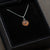 A gift box holding a sterling silver pendant space necklace with genuine Martian Mars meteorite dust inside! Space jewelry at its finest.