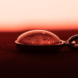 Side view of A sterling silver pendant space necklace with genuine Martian Mars meteorite dust inside! Space jewelry at its finest.