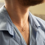 A man wearing a sterling silver pendant space necklace with genuine Martian Mars meteorite dust inside! Space jewelry at its finest.