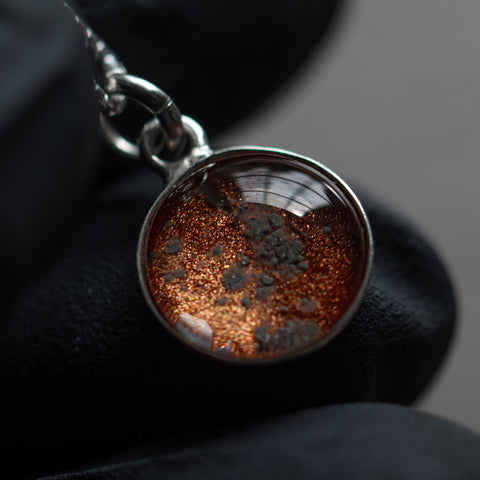 A sterling silver pendant space necklace with genuine Martian Mars meteorite dust inside! Space jewelry at its finest.