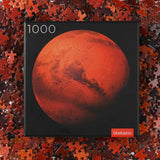 Round 1000 piece Mars puzzle - planet puzzle space gift - front of box with puzzle pieces in background