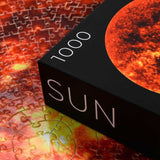 Round Sun Puzzle - 1000 piece space jigsaw puzzle - corner of box with puzzle pieces in background