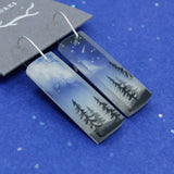 Starry night sky space jewelry earrings with milky way and forest trees scene.