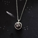 A beautiful and unique small round chunky raw meteorite necklace in a silver tone deep bezel. The perfect space-themed necklace jewelry gift!