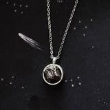 A beautiful and unique small round chunky raw meteorite necklace in a silver tone deep bezel. The perfect space-themed necklace jewelry gift!