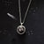 A beautiful and unique small round chunky raw meteorite necklace in a silver tone deep bezel. The perfect space-themed necklace jewelry gift!