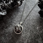 A beautiful and unique small round chunky raw meteorite necklace in a silver tone deep bezel. The perfect space-themed necklace jewelry gift!