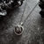 A beautiful and unique small round chunky raw meteorite necklace in a silver tone deep bezel. The perfect space-themed necklace jewelry gift!