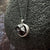A beautiful and unique small round chunky raw meteorite necklace in a silver tone deep bezel. The perfect space-themed necklace jewelry gift!