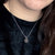 A beautiful and unique small round chunky raw meteorite necklace in a silver tone deep bezel. The perfect space-themed necklace jewelry gift!
