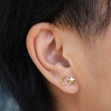 A mismatched pair of 14k solid yellow gold crescent moon and star stud earrings - the perfect space jewelry gift for a space or moon lover!