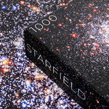 Starfield puzzle - 1000 piece rectangular galaxy space puzzle.- showing corner of box with puzzle pieces in background
