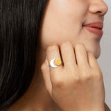 A sterling silver adjustable ring with a crescent moon and bronze sun - a unique space jewelry gift for space and astronomy lovers! Shown on a hand.