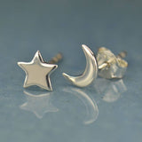A cute mismatched pair of sterling silver moon and star stud earrings - the perfect space jewelry gift for a space lover!