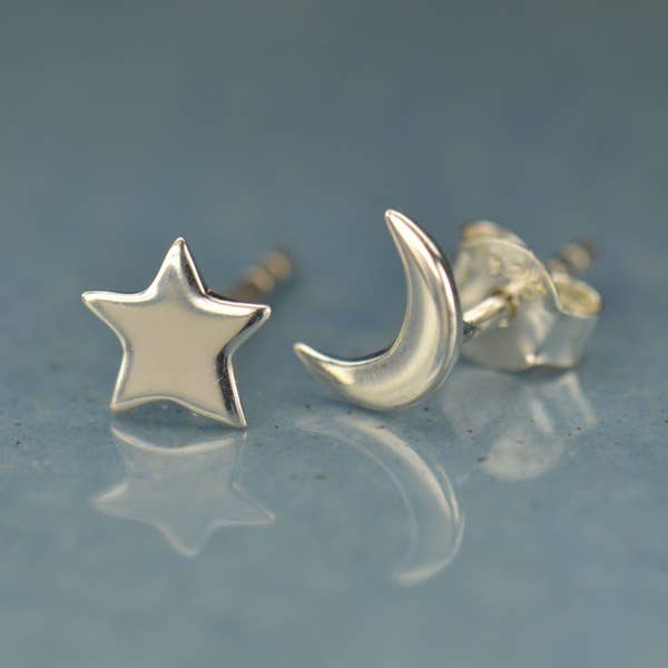 A cute mismatched pair of sterling silver moon and star stud earrings - the perfect space jewelry gift for a space lover!