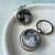A spinning Moon fidget keychain with a full moon on one side and new moon on the other side under glass. A fun space moon keychain gift for men or women!