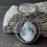 A spinning Moon fidget keychain with a full moon on one side and new moon on the other side under glass. A fun space moon keychain gift for men or women!