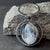A spinning Moon fidget keychain with a full moon on one side and new moon on the other side under glass. A fun space moon keychain gift for men or women!