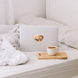 A vinyl heart moon sticker shown on a laptop, perfect for any lover of the moon or space!