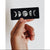 A hand holding a vinyl moon phase sticker, perfect for any lover of the moon or space!