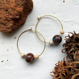 A unique pair of space earrings depicting planet Mars with it's two moons! Large brass space/planet themed hoop earrings. A fun space jewelry gift!