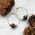 A unique pair of space earrings depicting planet Mars with it's two moons! Large brass space/planet themed hoop earrings. A fun space jewelry gift!