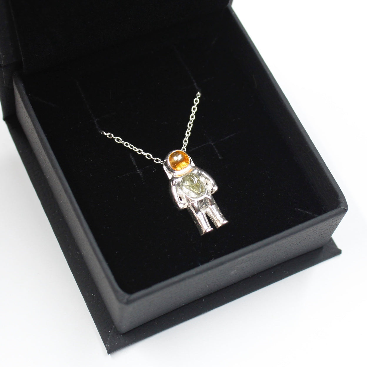Sterling Silver astronaut pendant necklace with green moldavite glass and gold enamel helmet visor - the perfect space gift! Shown in gift box.