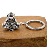Astronaut key chain of a spaceman meditating. The perfect space gift!