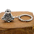 Astronaut key chain of a spaceman meditating. The perfect space gift!