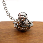 Astronaut key chain of a spaceman meditating. The perfect space gift!