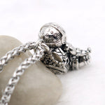 Astronaut necklace showing a spaceman meditating. The perfect space gift!