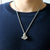 Man wearing an astronaut pendant showing a spaceman meditating. The perfect space gift!