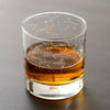 Outer space themed whiskey rocks glass showing northern summer night sky zodiac constellations